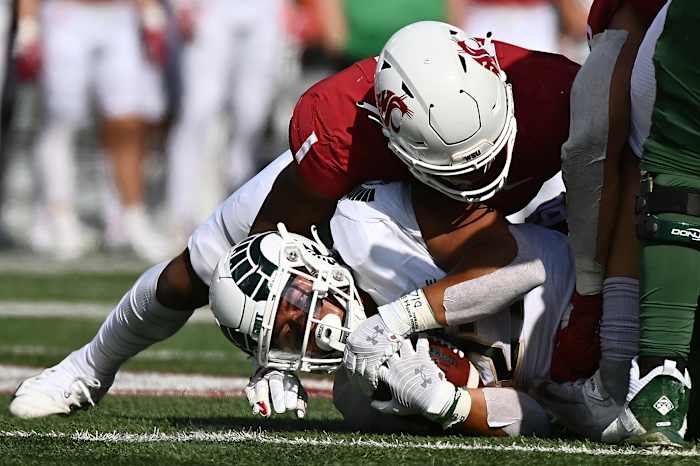 Washington State Cougars linebacker Daiyan Henley tackles Colorado State running back Jaylen Thomas in week 3.